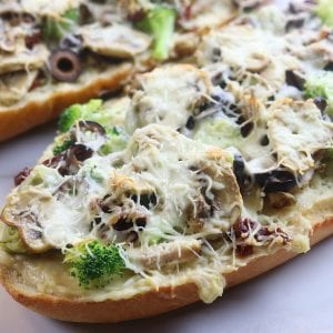 Chicken Béchamel French Bread Pizza is a quick and easy family favorite recipe. One of the best homemade pizza that is perfect with rotisserie chicken or leftover Thanksgiving turkey. Simple ingredients and takes only minutes to bake.