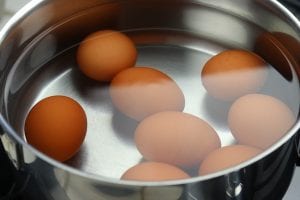 Eggs submerged in water before boiling.