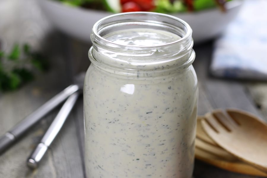 Creamy Homemade Ranch Dressing with two forks and a large salad.