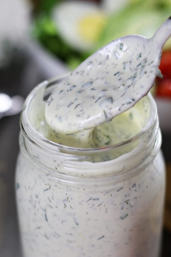 Spoon dipping into Homemade Ranch Dressing.