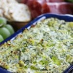 Lemon Artichoke Dip sitting among other appetizers