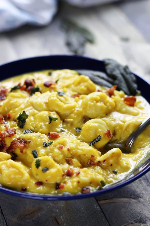 Bowl of Tortellini Butternut Squash Soup with bacon and crispy sage.