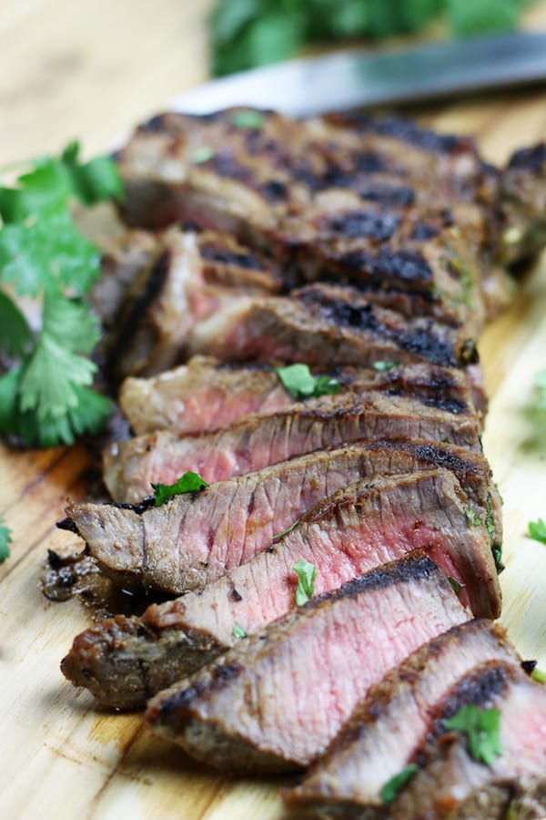 Carne Asada Meat slices on a wooden board.