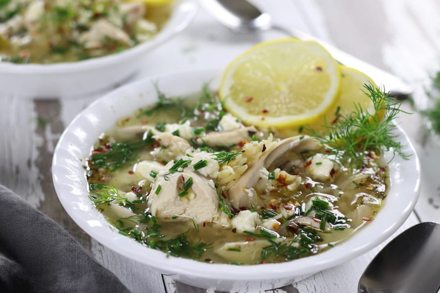 Greek Lemon Chicken Soup with orzo on a table top.