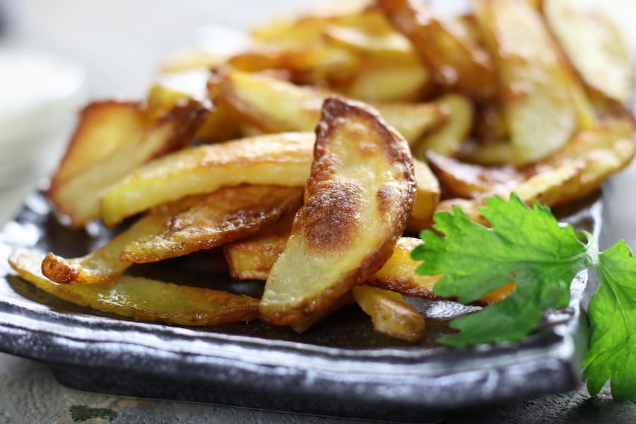 Several Homemade Baked French Fries on a plate.