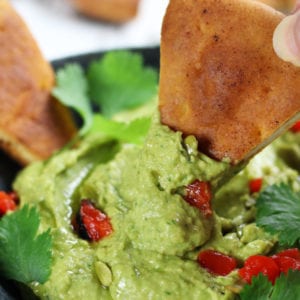 A bowl of Avocado Hummus with Cumin and Cilantro.