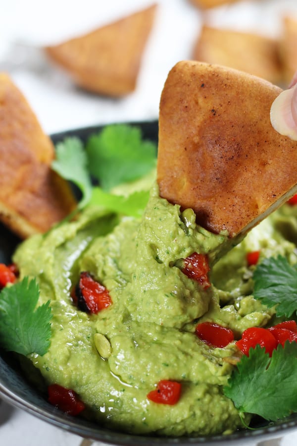 A bowl of Avocado Hummus with Cumin and Cilantro.