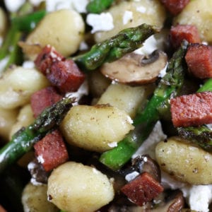 Easy Gnocchi Recipe with crispy salami, sautéed asparagus, mushrooms, gnocchi and chèvre.