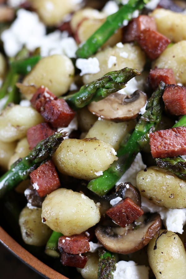 Easy Gnocchi Recipe with crispy salami, sautéed asparagus, mushrooms, gnocchi and chèvre.