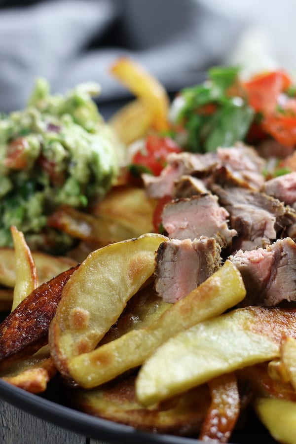 Photo of a classic San Diego Style Carne Asada Fries plate.