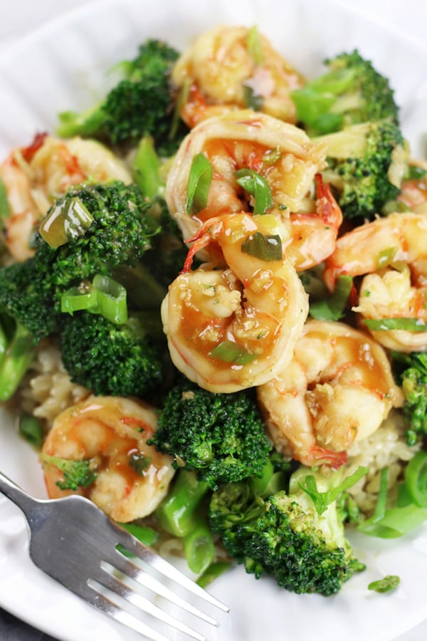 Shrimp Stir Fry with broccoli and rice on a white plate.