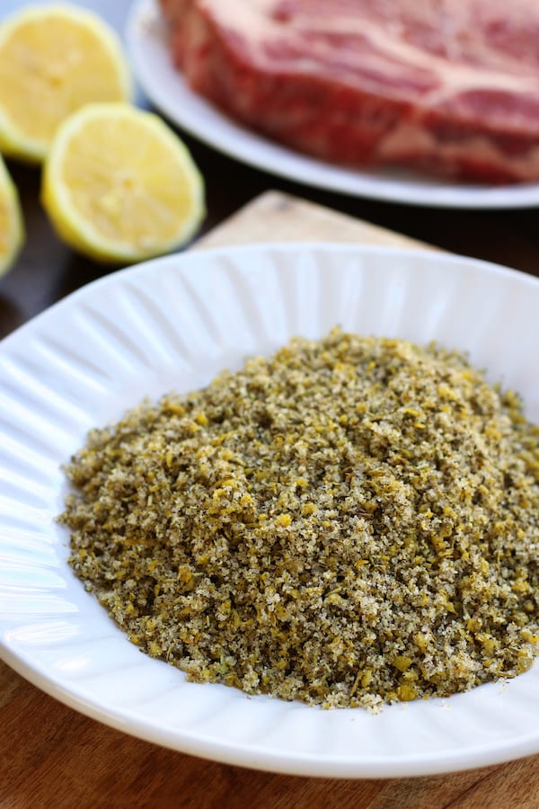 Beef Rub sitting on a plate with chuck roast and lemons behind.