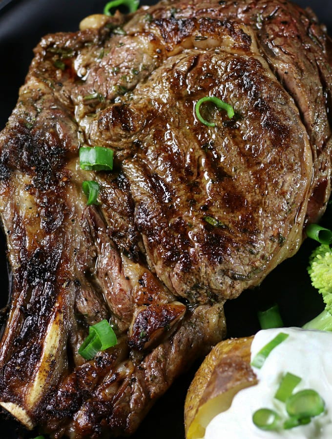 Over head photo of a grilles rib eyes steak marinated in the Best Rib Eye Steak Marinade.