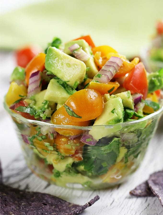 Chunky Guacamole Salsa with blue tortilla chips.