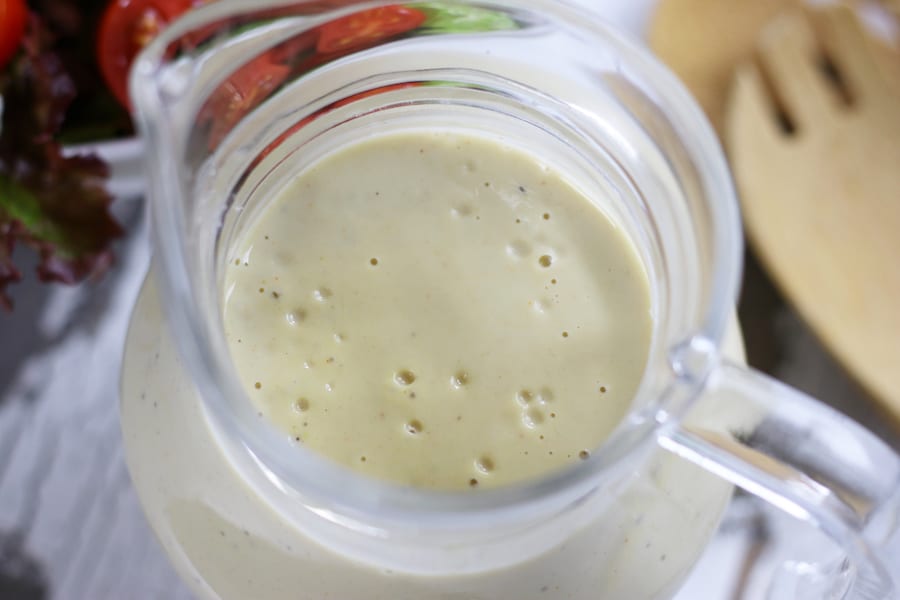 Over head picture of Creamy Lemon Salad Dressing in a container.