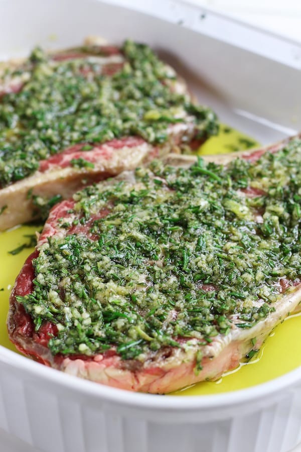 Two steaks marinating in Grilled Rib Eye Steak Marinade.