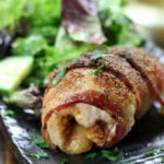 Bacon Wrapped Chicken on a plate with salad.