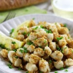 A plate full of Broiled Scallops with Lemon Parmesan Panko.