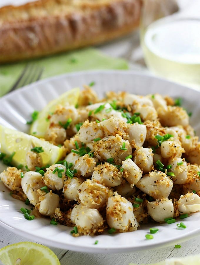 A plate full of Broiled Scallops with Lemon Parmesan Panko.