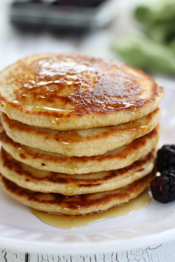 Easy Oat Flour Pancakes on a white plate with blackberries.