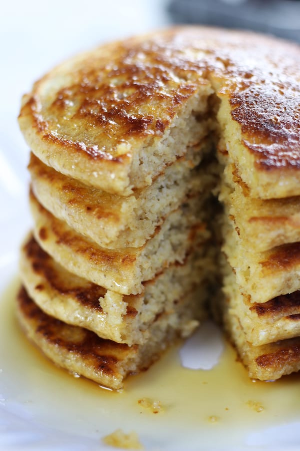Stack of Fluffy Oat Flour Pancakes with slices cut out.