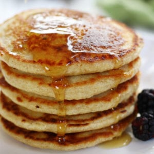 Syrup being poured on a stack of Gluten Free Oatmeal Pancakes.