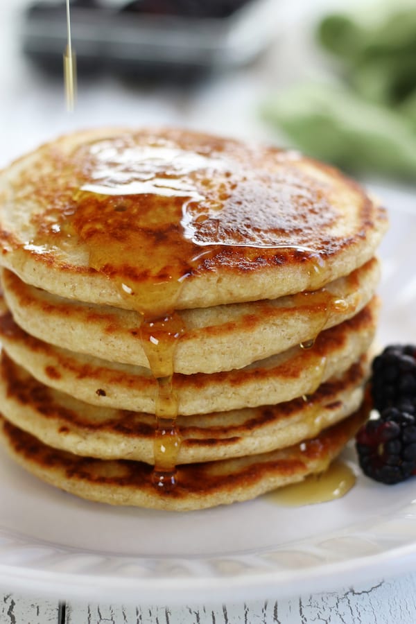 Syrup being poured on a stack of Gluten Free Oatmeal Pancakes.