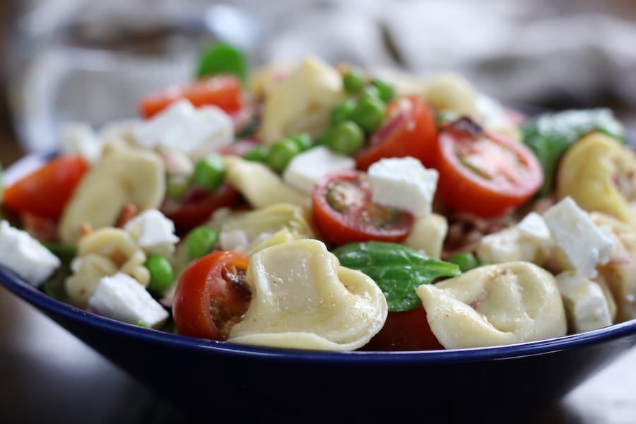 A big blue bowl of Tortellini Pasta Salad Recipe.