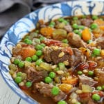 Beef Barley Soup in a blue and white bowl.