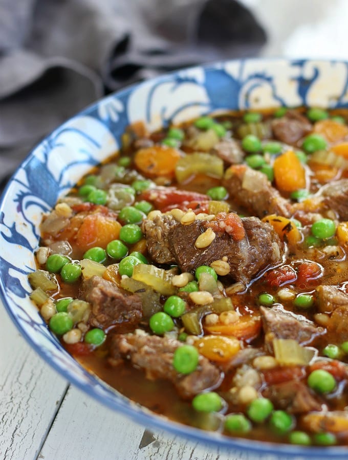 Beef Barley Soup in a blue and white bowl.