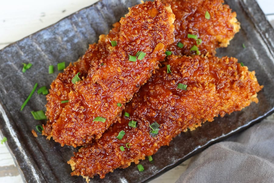 Three Chicken Fingers with Panko crust and sticky Asian sauce.