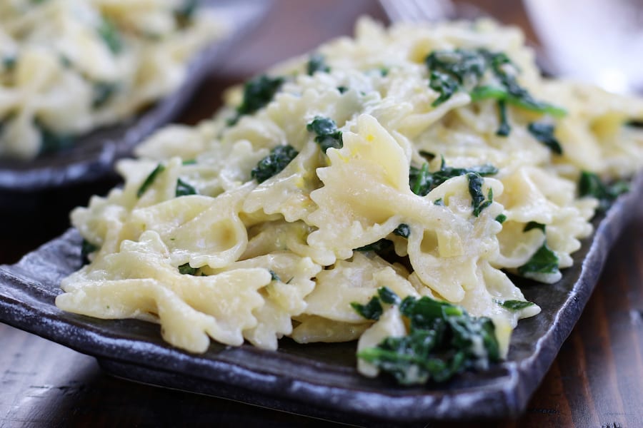 Up close photo of a single serving of Creamy Pasta with Spinach.