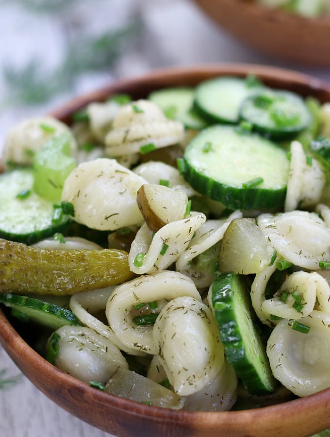 Dill Pickle Pasta Saladin a brown wooden bowl.