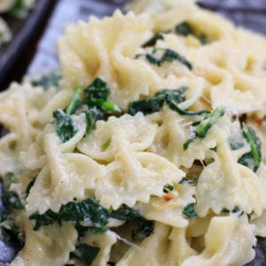 Easy Bow Tie Pasta with Spinach on a plate with melted parmesan.