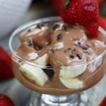 Chocolate Yogurt Fruit Dip Parfait with cut banana and cacao nibs.