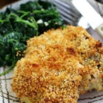 Crispy Baked Pork Chops recipe on a plate with spinach.