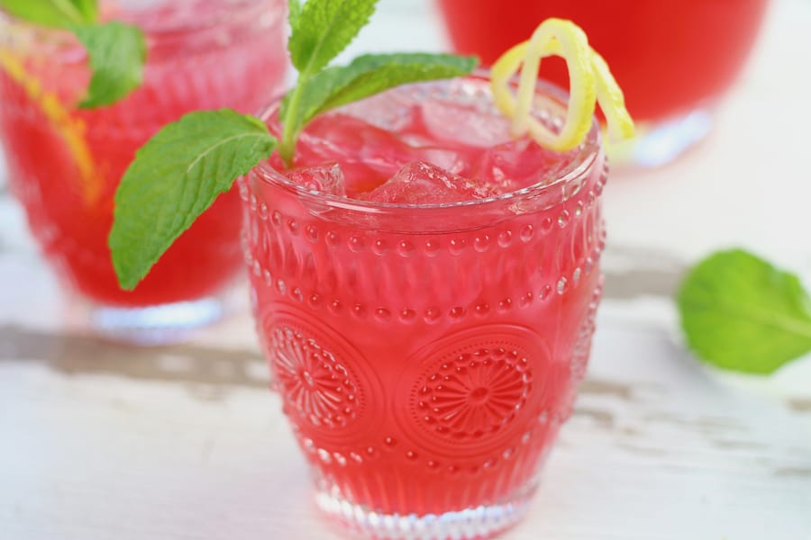 Two glasses of icy cold Hibiscus Lemonade with mint.