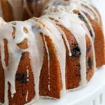 Lemon Blueberry Bundt Cake on a white cake stand.