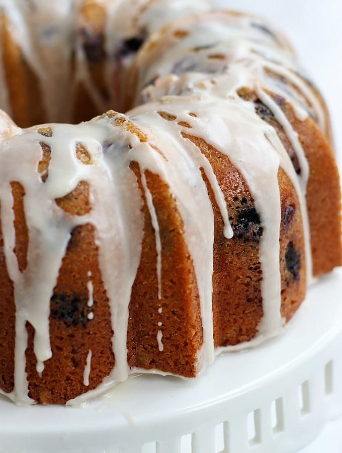 Lemon Blueberry Bundt Cake on a white cake stand.