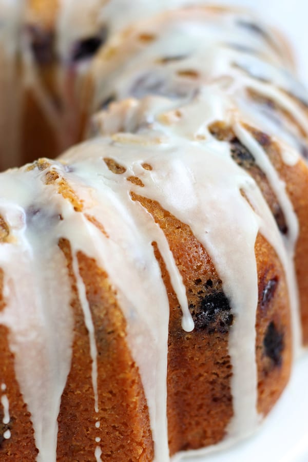 Lemon Blueberry Cake Recipe with a buttery exterior and glaze drippings.