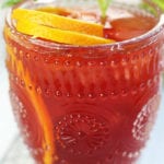 Up close photo of Passion Fruit Orange Mocktail in an etched glass.