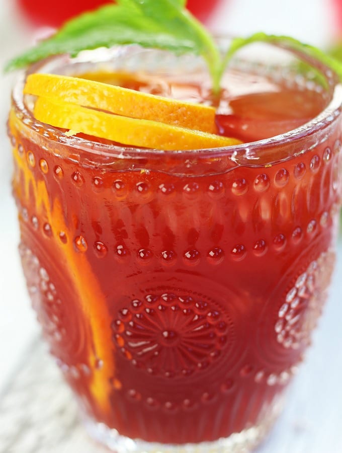 Up close photo of Passion Fruit Orange Mocktail in an etched glass.