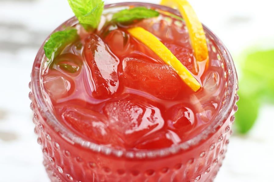 Overhead photo of a glass of Passionfruit Cooler with ice.