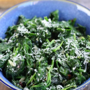 Sautéed Spinach in a blue bowl with parmesan.