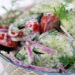 Cucumber Tomato Salad in a patterned blue bowl.