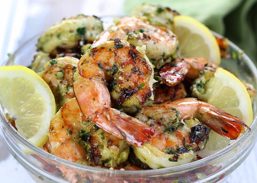 Large grilled Lemon Garlic Shrimp on a clear bowl.