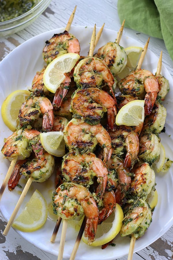 Overhead shot of Lemon Garlic Shrimp Skewers on a white table.