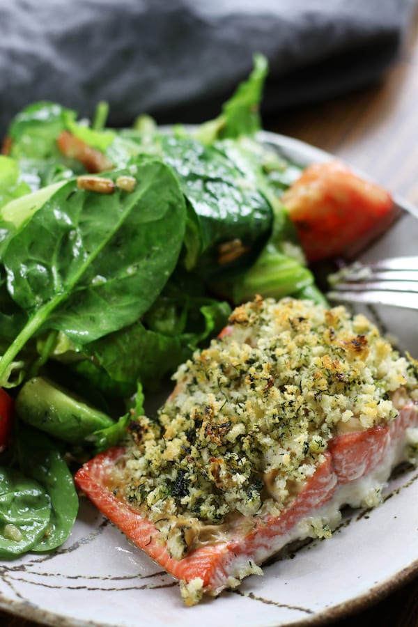 Panko Crusted Salmon on a plate with spinach salad.