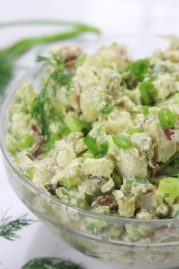 Red Potato Salad garnished with Green onions and fresh dill.