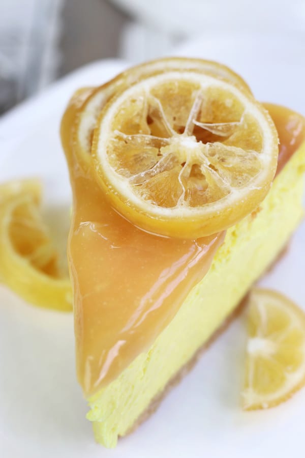 Single slice of Baked Lemon Cheesecake with candied lemon slices.